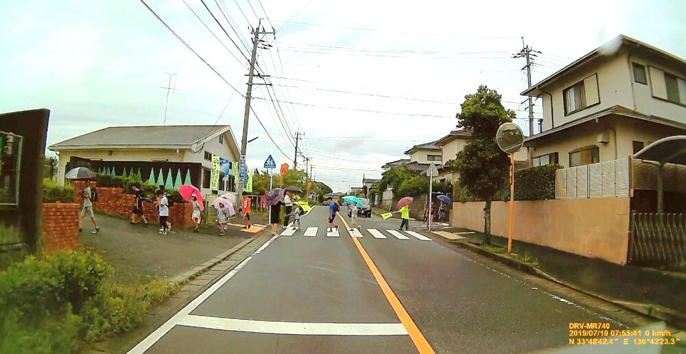 西小学校正門前横断歩道を渡る子どもたちの写真